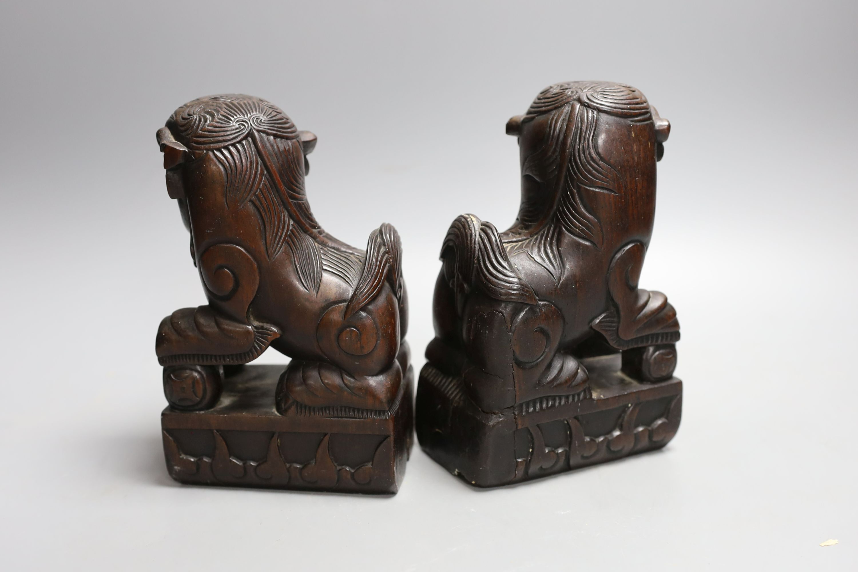 A pair of Chinese hongmu Buddhist lion figures, late 19th century - 18cm high